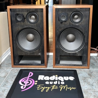 Pioneer CS-77 pair with grilles off: black baffles, each with a large woofer, a midrange cone and a tweeter above, and a slot port at the base, in walnut cabinets