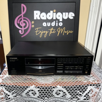 Pioneer PD-7700 compact disc player, front panel with disc tray and transport buttons, on lace in front of the Radique backdrop