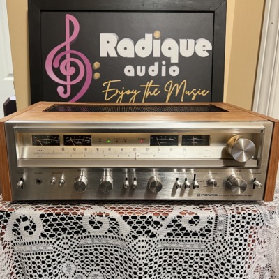 Pioneer SX-880 stereo receiver in a cherry wood cabinet, brushed silver faceplate with wide tuning dial, meters, rotary knobs and lever switches