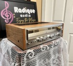 Pioneer SX-880 stereo receiver from the front left, showing the grain of the cherry wood cabinet side and the silver faceplate with its big tuning knob