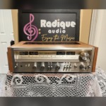 Pioneer SX-880 stereo receiver in a cherry wood cabinet, brushed silver faceplate with wide tuning dial, meters, rotary knobs and lever switches