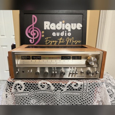 Pioneer SX-880 stereo receiver in a cherry wood cabinet, brushed silver faceplate with wide tuning dial, meters, rotary knobs and lever switches