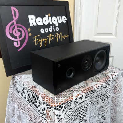 Polk Audio CS175 center channel speaker seen at an angle with the grille off, matte black cabinet, port, tweeter and woofer