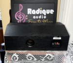 Rear of the Polk Audio Monitor CS2 Series II, black wood-grain back with a round bass port, model label and binding posts