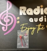 Radique Audio small spade adapters, red and black pair packed in a clear bag with a Radique Audio label