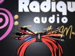 Both ends of the Radique House CCA pair up close: red and black Radique banana plugs on one side, crimped small spade forks on the other
