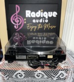 Rear of the Sansui P-50 seen from slightly above with the cover closed, Sansui model label, cable plate and bundled cables