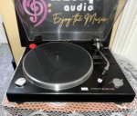 Close view of the Sansui P-50 deck: speed selector, platter with silver rim, tonearm with white cartridge and the P-50 badge