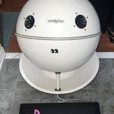 SoundSphere 2212-1 omnidirectional speaker, white sphere with the soundsphere name badge, two tweeters and a 22 decal, resting on a white dish