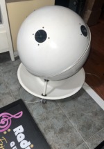 SoundSphere 2212-1 sphere seen from above at an angle, white fiberglass shell with seam trim, tweeters and the dish base below