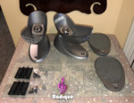 Silver Tannoy Arena cast bases with their speaker cradles, the two grilles, black wall plates and fixing screws laid out together