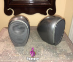 Silver Tannoy Arena satellites, one facing forward with its grille on and one turned to show its curved side
