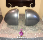 Silver Tannoy Arena satellites seen side-on, showing the smooth curved cast aluminum shells