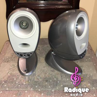 Silver Tannoy Arena satellites on matching cast bases, one facing forward and one angled on its ball joint