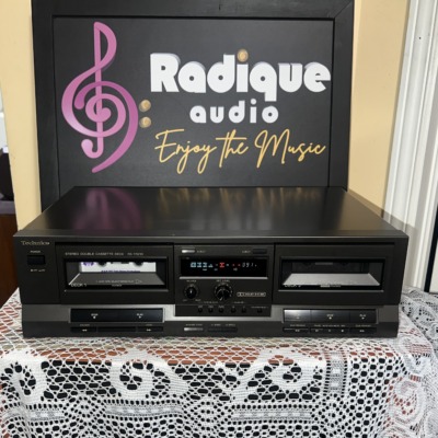 Technics RS-TR210 double cassette deck in black, deck 1 and deck 2 wells with a blue level display, balance and record level knobs