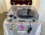 Rear of the Technics SL-220 turntable with the dust cover closed, its model label, braided Gold Series RCA cables and power cord