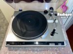 Technics SL-220 turntable from above with the lid open: rubber platter mat, S-type tonearm, arm rest, speed and pitch controls