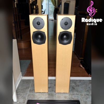 Pair of Totem Acoustic Sttaf floorstanding speakers in maple veneer, front view with grilles off showing the tweeter and 5.5-inch driver