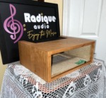 Radique Audio WC-10 style cherrywood cabinet from the left at an angle, showing the cherry grain on the top and side panels
