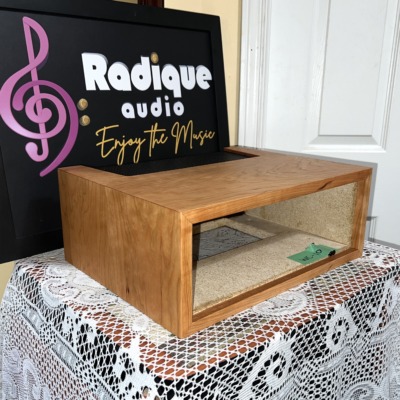 Radique Audio WC-10 style cherrywood cabinet from the left at an angle, showing the cherry grain on the top and side panels