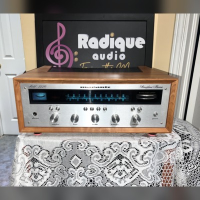 Marantz 2220 stereo receiver in custom Ottawa Valley cherry cabinet — front view, silver faceplate and blue dial illumination.