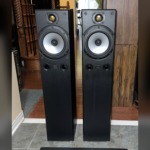 Pair of Monitor Audio Bronze 3 floorstanding speakers, grilles off, gold dome tweeters above silver mid-bass drivers and twin front ports