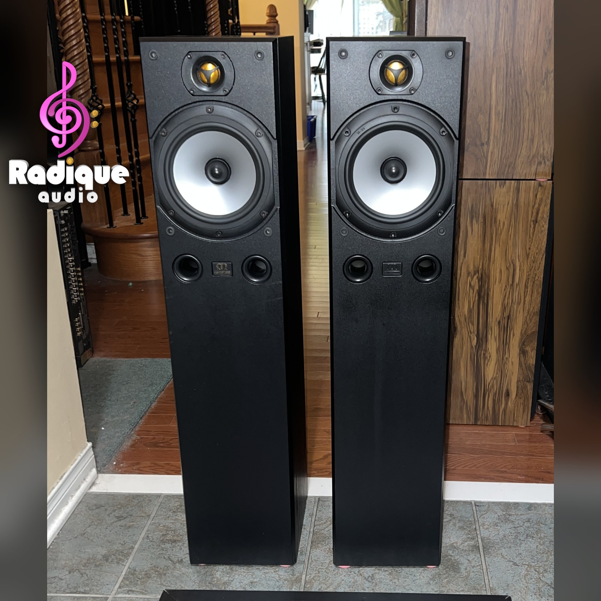 monitor-audio-bronze-3-floorstanding-speakers-front-thumb-Logo Pair of Monitor Audio Bronze 3 floorstanding speakers, grilles off, gold dome tweeters above silver mid-bass drivers and twin front ports